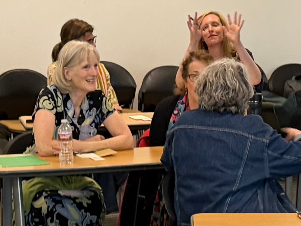 Attendees in conversation with notebooks on the table